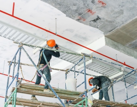 worker installing cable tray with electrical wiring arrange ceiling offshore platfor 1