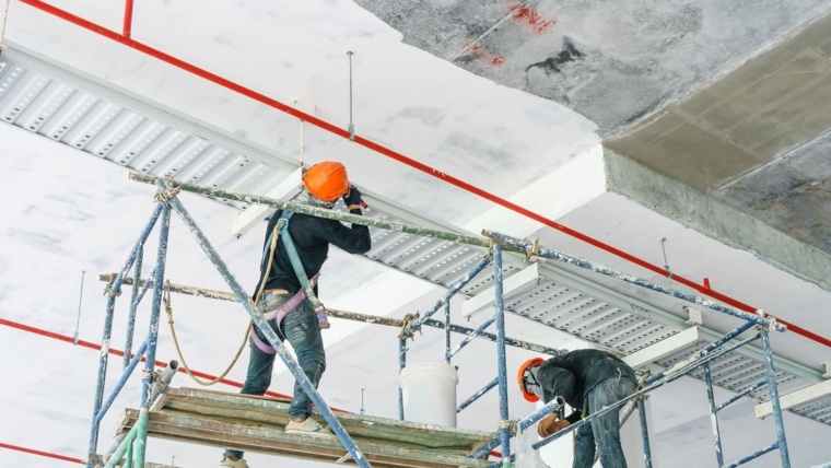 worker installing cable tray with electrical wiring arrange ceiling offshore platfor 1