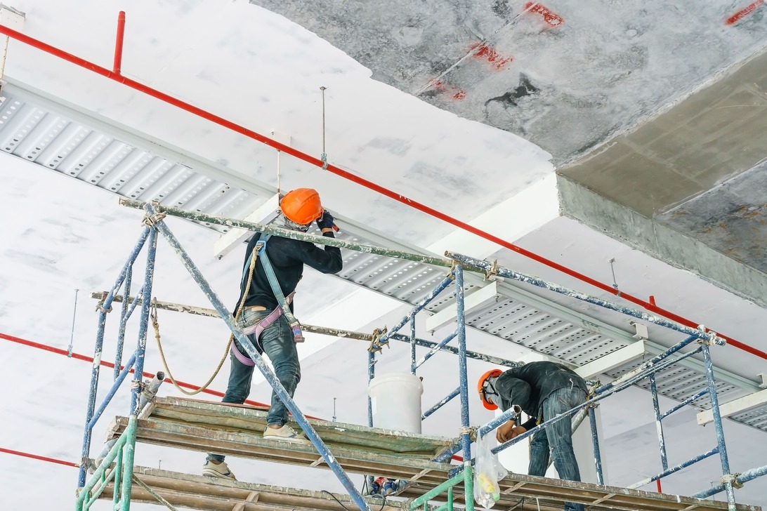 worker installing cable tray with electrical wiring arrange ceiling offshore platfor 1